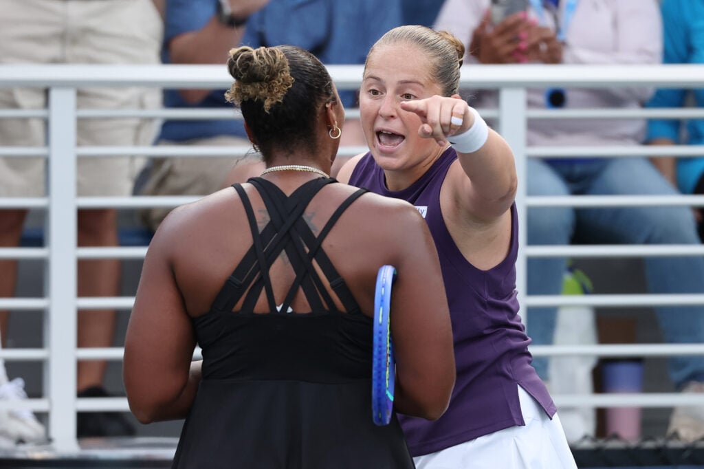 Jelena Ostapenko and Taylor Townsend argue at the net after their match at the 2025 US Open