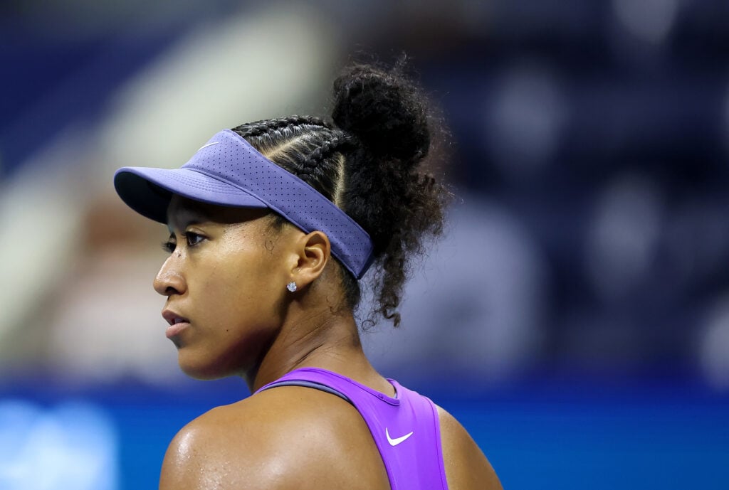 Naomi Osaka looks on during her semifinal match with Amanda Anisimova at the 2025 US Open