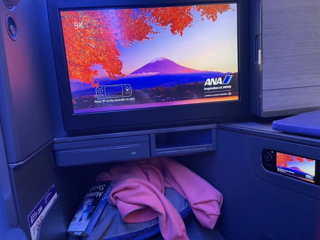 A foot well under the large IFE screen in the ANA business class seat.