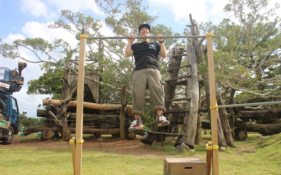 a man doing pull-ups on a horizontal bar