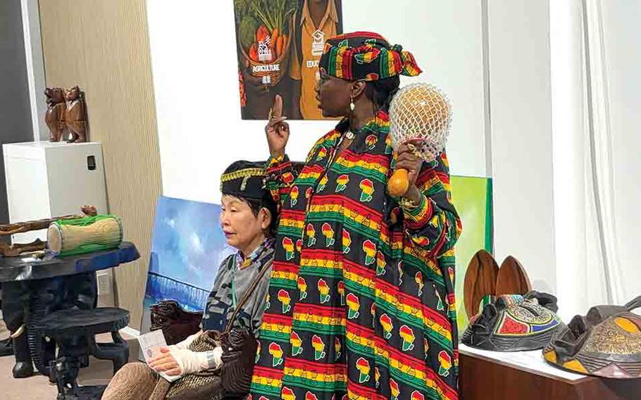 a woman showing her country’s traditional instruments.