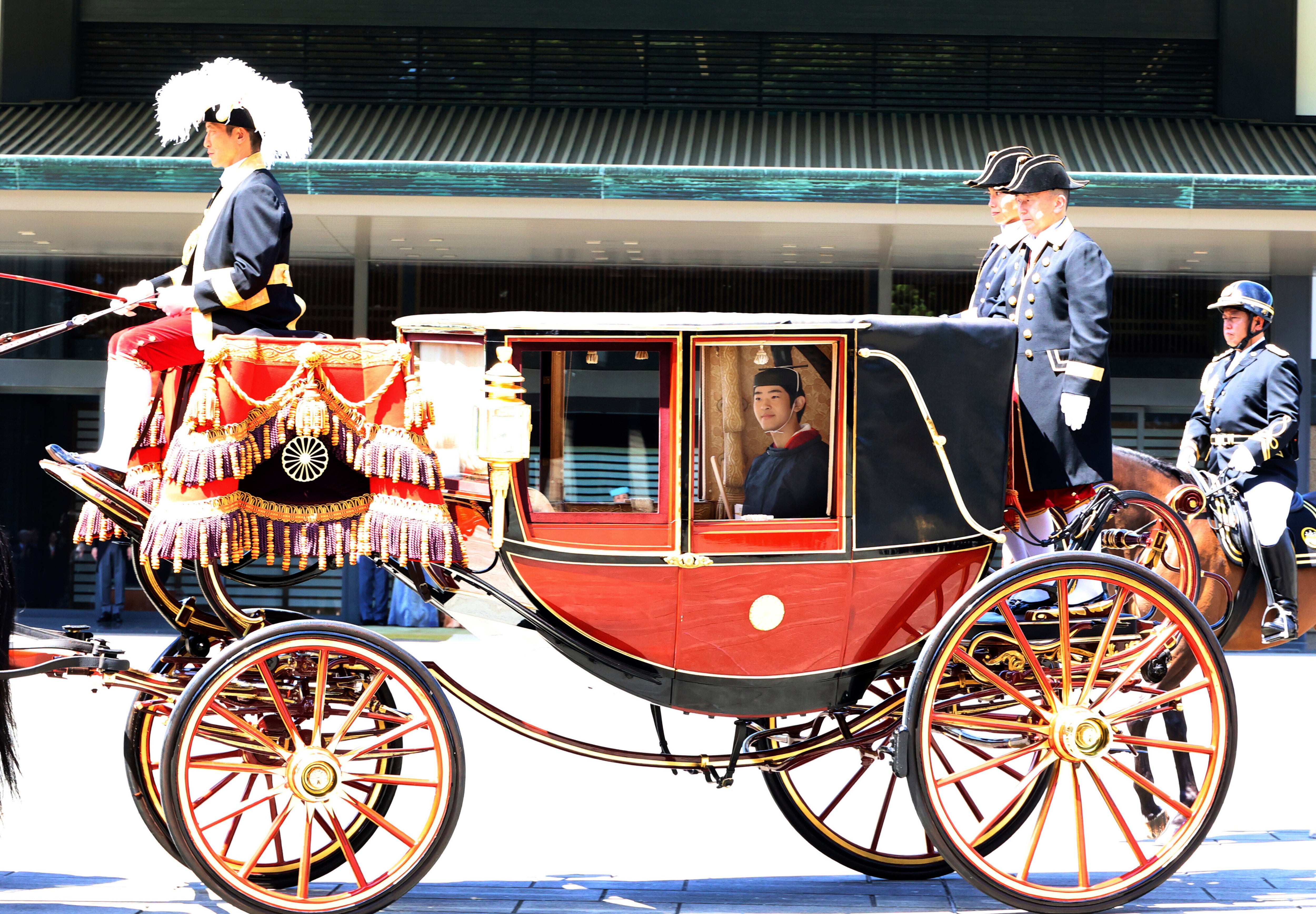 Japanese Prince Hisahito, son of Crown Prince Akishino, wearing ancient ceremonial costume, leaves for a ceremony in a carriage at the Imperial Palace in Tokyo