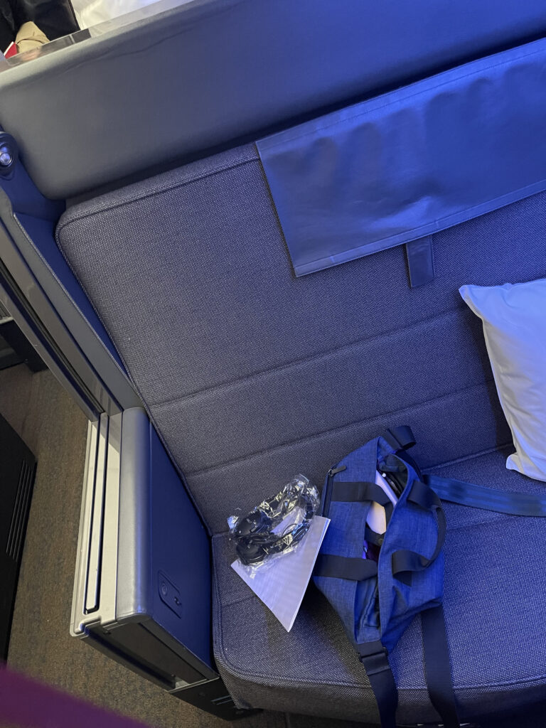 The ANA business class seat is all grey with a pillow, headset and an interesting blue amenity bag.