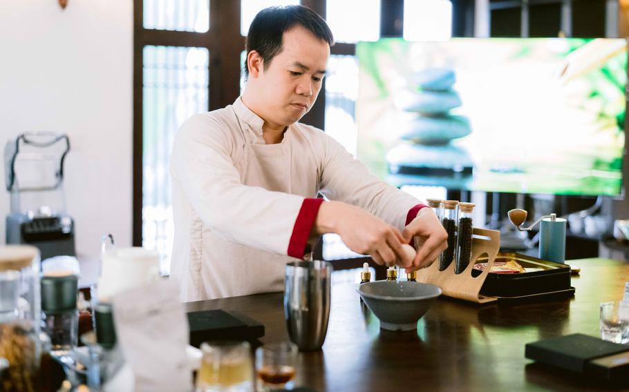 A man is making coffee in the Coffee-making class in Hanoi.