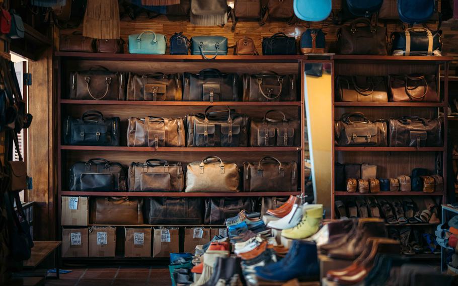 Bags and shoes are displayed in the Kha Thi Leather Shop in Hoi An.