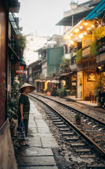 A person stands by the railway track.