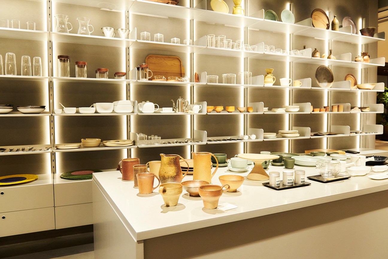 Retail shelving with neatly arranged high-end pottery and products