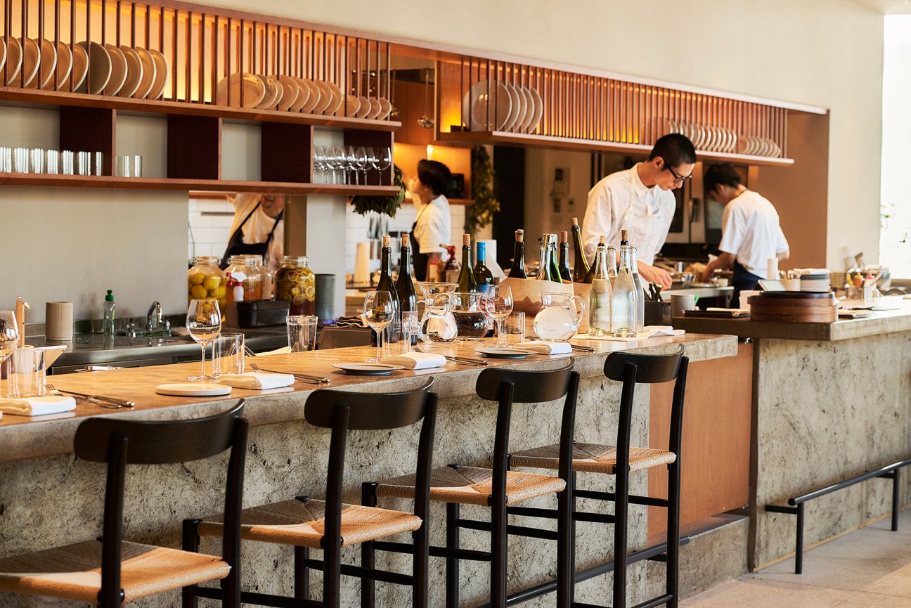 Elegant restaurant interior with natural light and wooden decor.