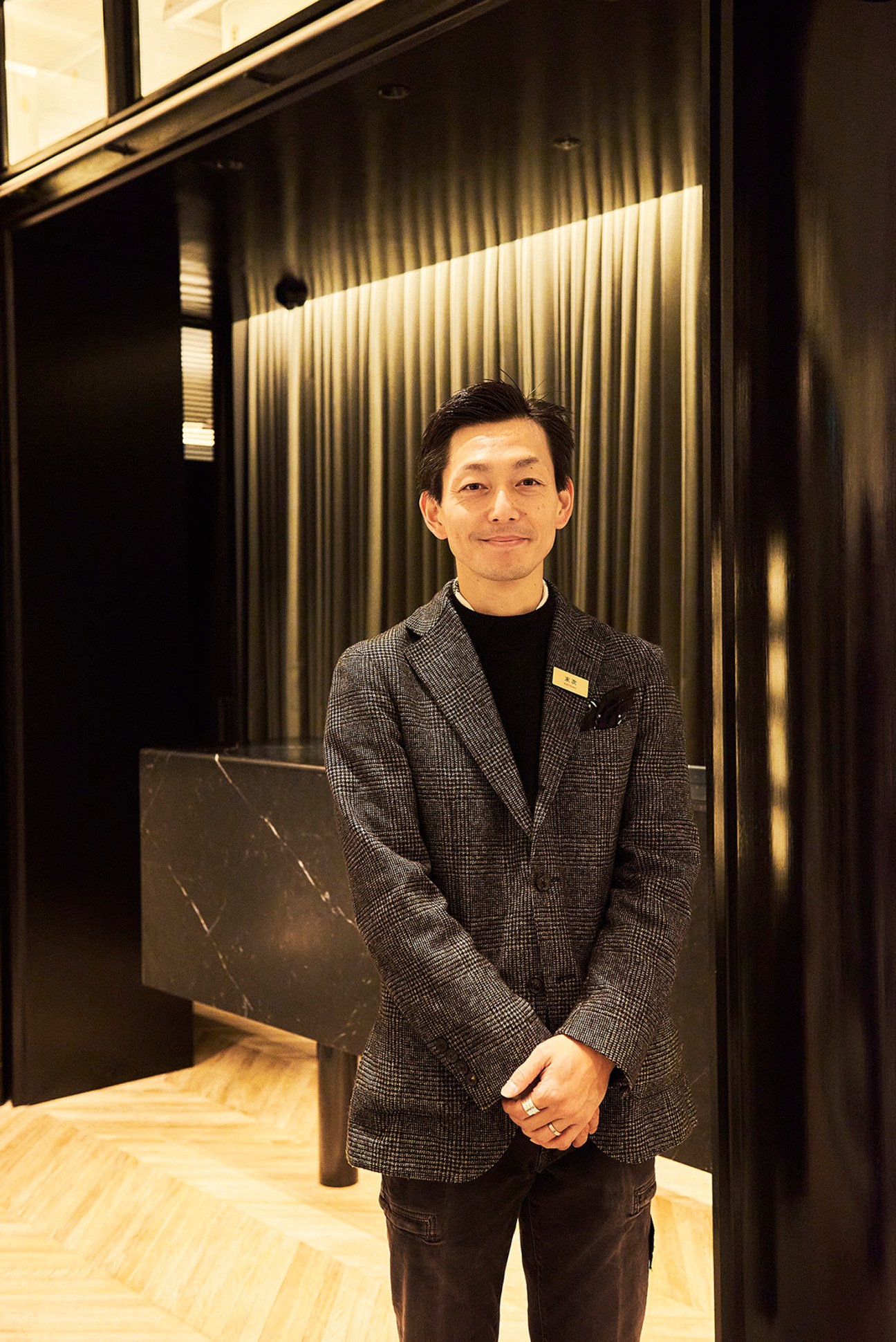 Man in formal attire posting for a photo