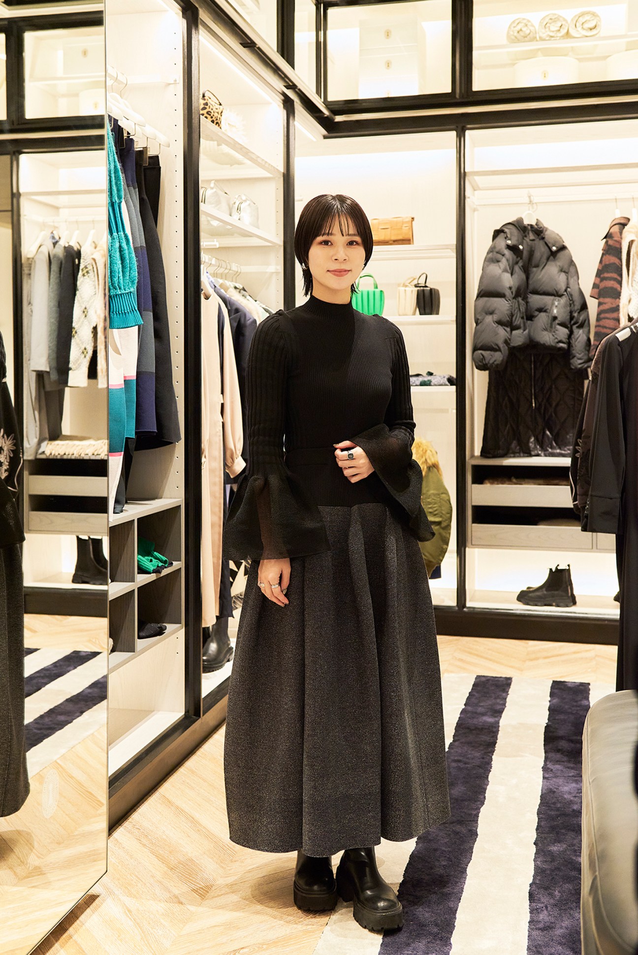 Stylishly dressed woman walking through a shopping area