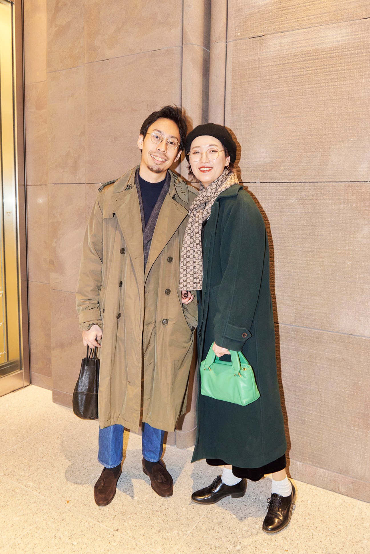 Two well-dressed individuals standing in front of a fashion boutique