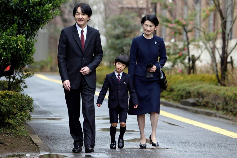 Japan's Prince Hisahito, center, accompanied by his father Prince Akishino and mother Princess Kiko, arrives at Ochanomizu University-affiliated kindergarten for his graduation ceremony in Tokyo on March 14, 2013.