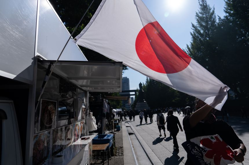 A vendor displays a Japanese national flag outside his food truck at the Yasukuni Shrine on August 15, in Tokyo, Japan.