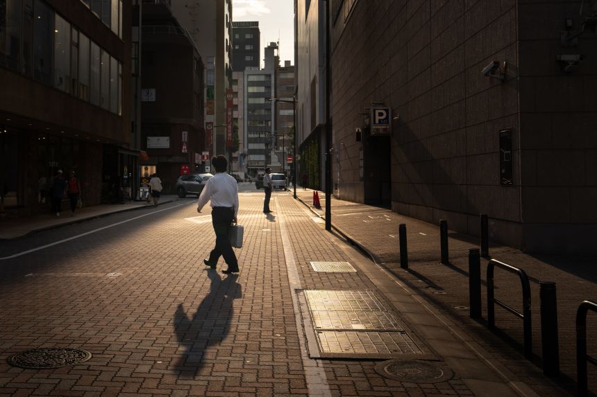 A man crosses a road during hot weather on August 21, 2025 in Tokyo, Japan.