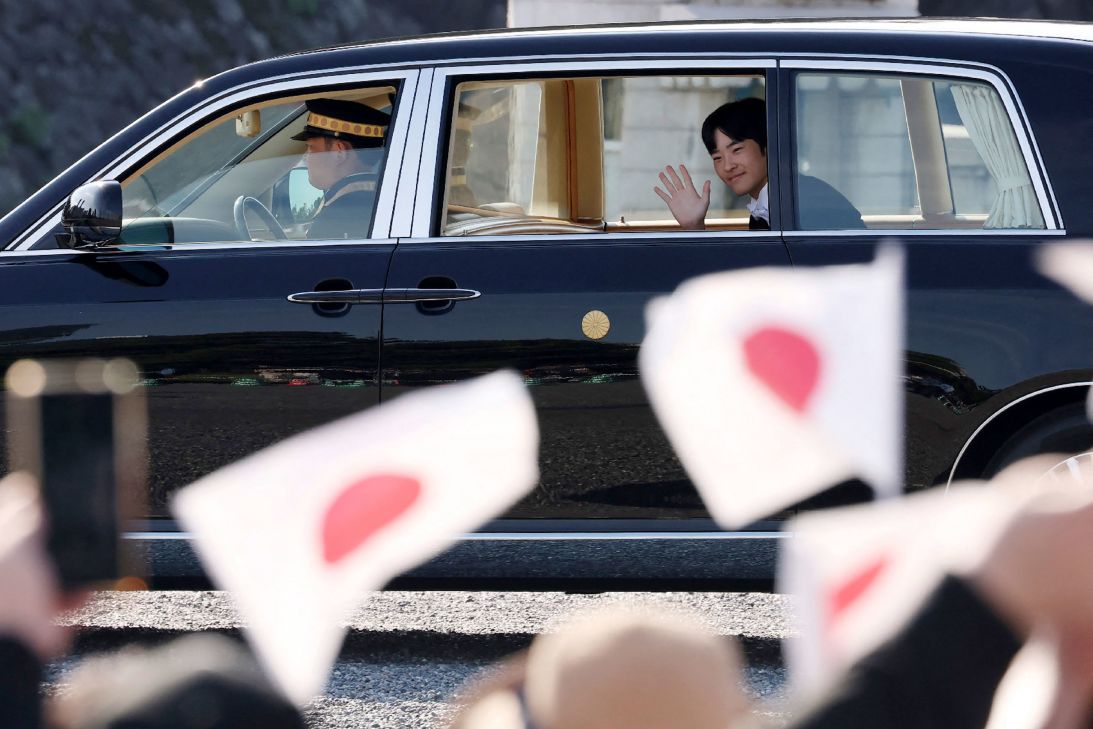 Japan's Prince Hisahito waves to people gathered in front of the Imperial Palace for his coming-of-age ceremony in Tokyo on Saturday.