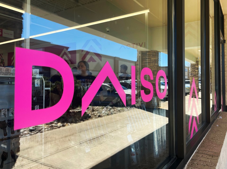 Daiso store window with pink logo.
