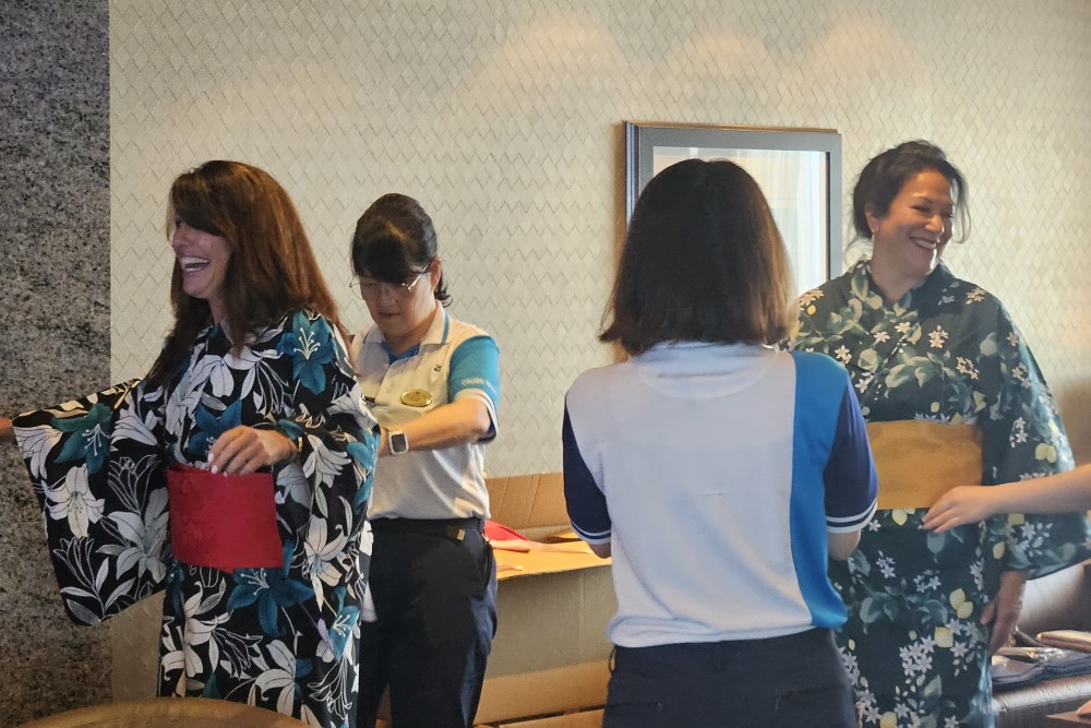 english-speaking passenengers trying on a kimono onboard mitsui ocean fuji cruise ship