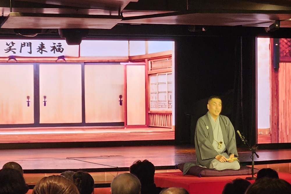 a japanese man telling stories during a rakugo session on mitsui ocean fuji cruise ship