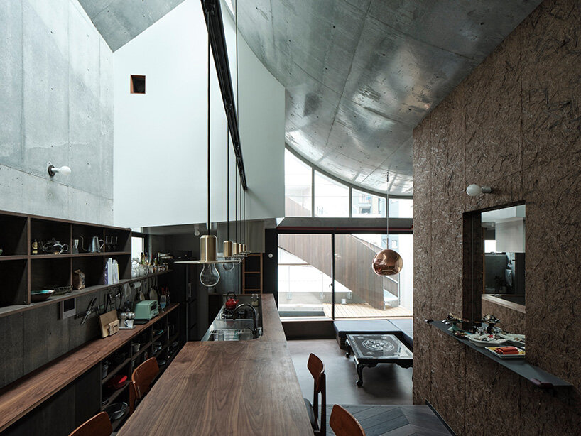 semi-cylindrical roof brings daylight into AOIM's three-story residence in tokyo
