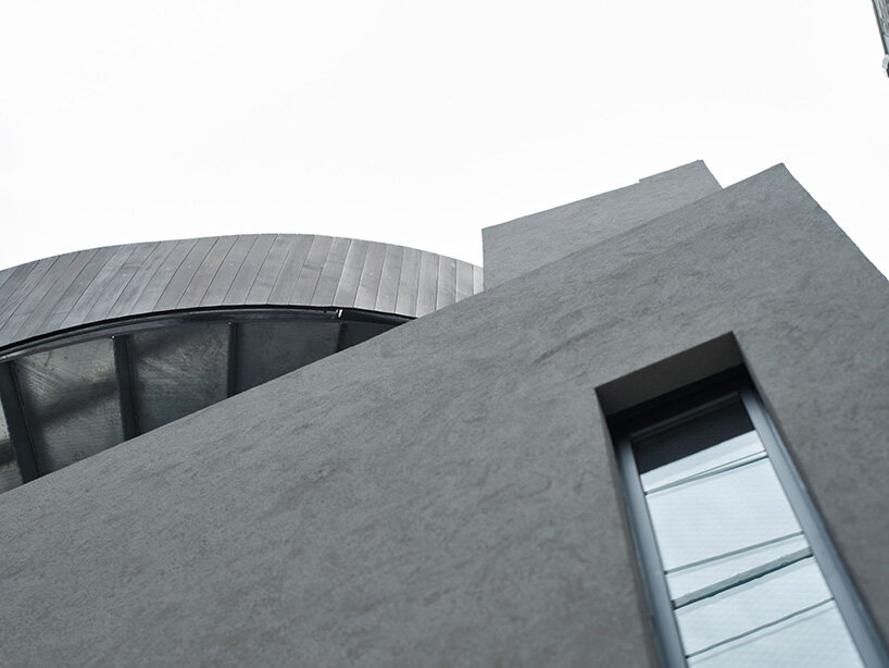 semi-cylindrical roof brings daylight into AOIM's three-story residence in tokyo