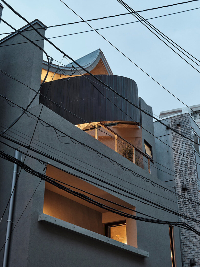 semi-cylindrical roof brings daylight into AOIM's three-story residence in tokyo