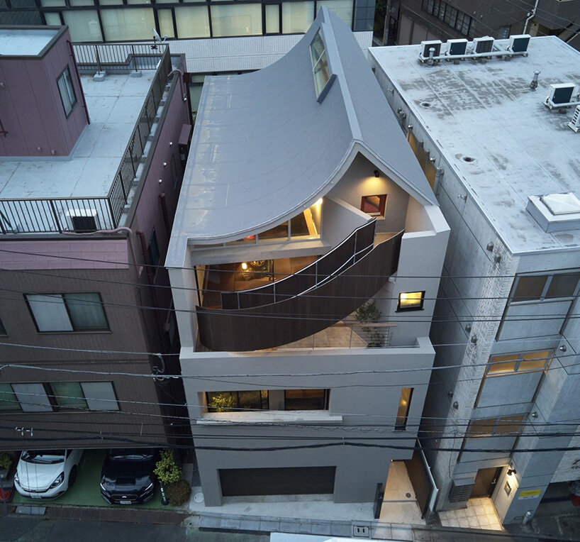 semi-cylindrical roof brings daylight into AOIM's three-story residence in tokyo