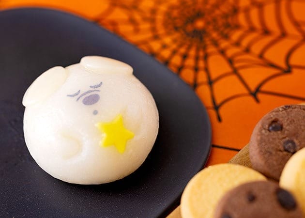 Round white pastry with a cute sleeping face, yellow star, and cookies—2025 Halloween Merchandise at Tokyo Disney Resort.