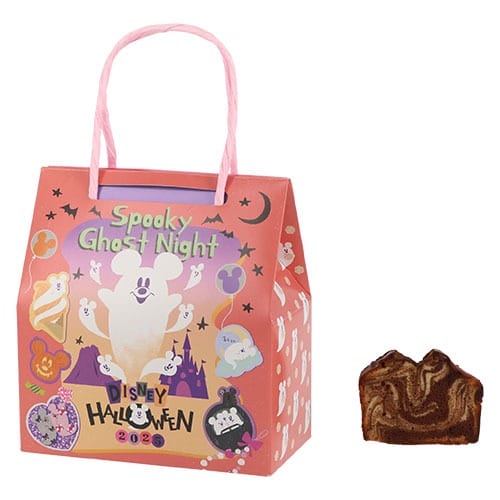 Pink Disney Halloween 2024 gift bag with ghost design, beside a slice of marbled chocolate cake—Tokyo Disney Resort Halloween merchandise.