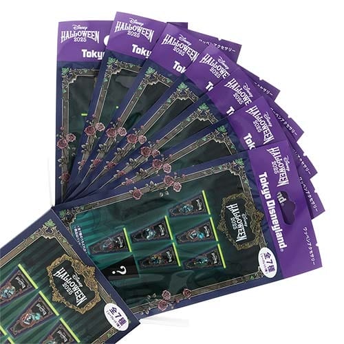 A fan arrangement of Tokyo Disney Resort Halloween merchandise sticker sheets with a purple and green Haunted Mansion theme.