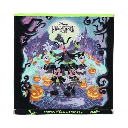 A Tokyo Disney Resort Halloween merchandise towel featuring Mickey, Minnie, and Goofy in costumes with jack-o’-lanterns.
