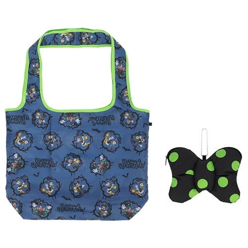 Blue tote bag with Tokyo Disney Resort 2025 Halloween pattern and green trim, next to a black bow pouch with green dots.
