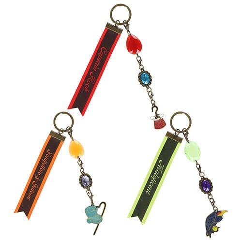 Three keychains with colored ribbons, gemstone charms, and themed pendants from the 2025 Halloween Merchandise collection.