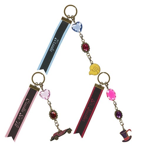 Three decorative keychains with ribbons, gems, and themed charms from Tokyo Disney Resort Halloween merchandise 2025.