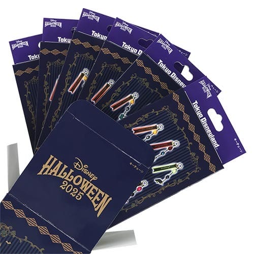 Six packs of Tokyo Disney Resort 2025 Halloween merchandise pins with colorful designs on dark packaging.