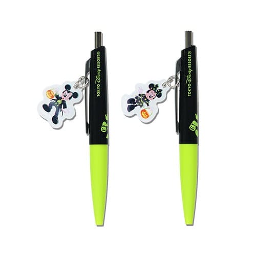 Two black and neon yellow pens with 2025 Halloween Merchandise charms from Tokyo Disney Resort attached to the clips.