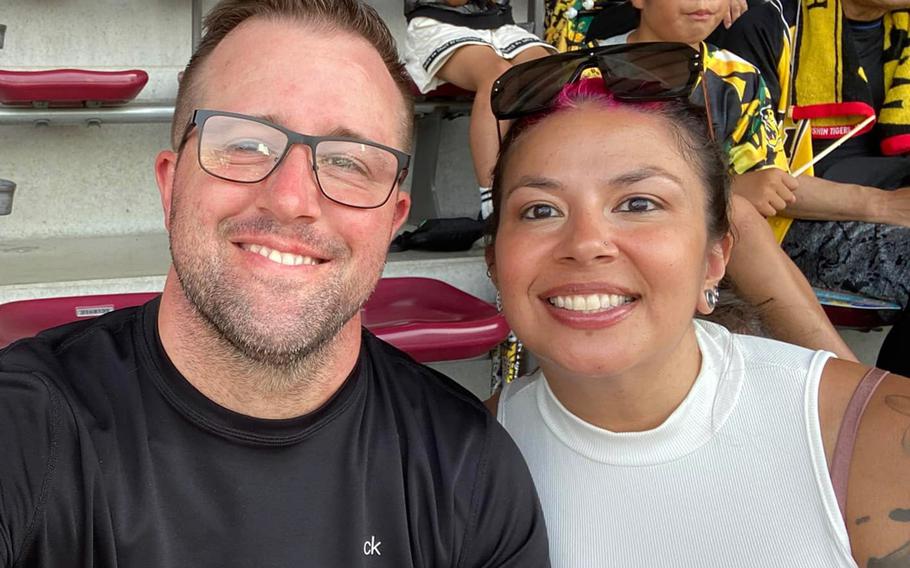 A man and a woman pose for a photo.