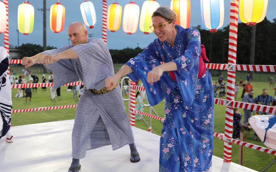 U.S. Army Garrison Japan commander Col. Erik Davis dances with his wife during the annual Bon Odori festival at Camp Zama, near Tokyo, Aug. 2, 2025. 
