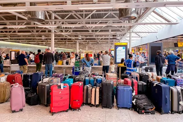 Stock picture of people waiting for baggage at Terminal 3 