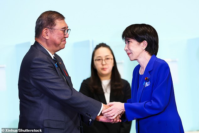Takaichi shakes hands with Japanese prime minister Shigeru Ishiba after winning the presidential election at the LDP headquarters in Tokyo on October 4