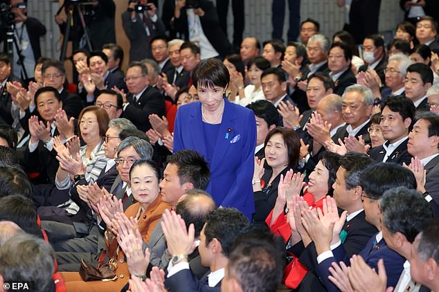 Takaichi receives a round of applause after beating her closest competitor Shinjiro Koizumi