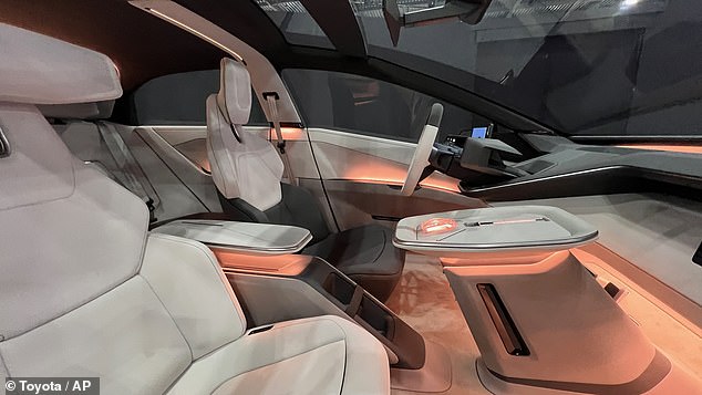 The driver and front passenger having their own displays that are separated by an island column with the drive selector and start button