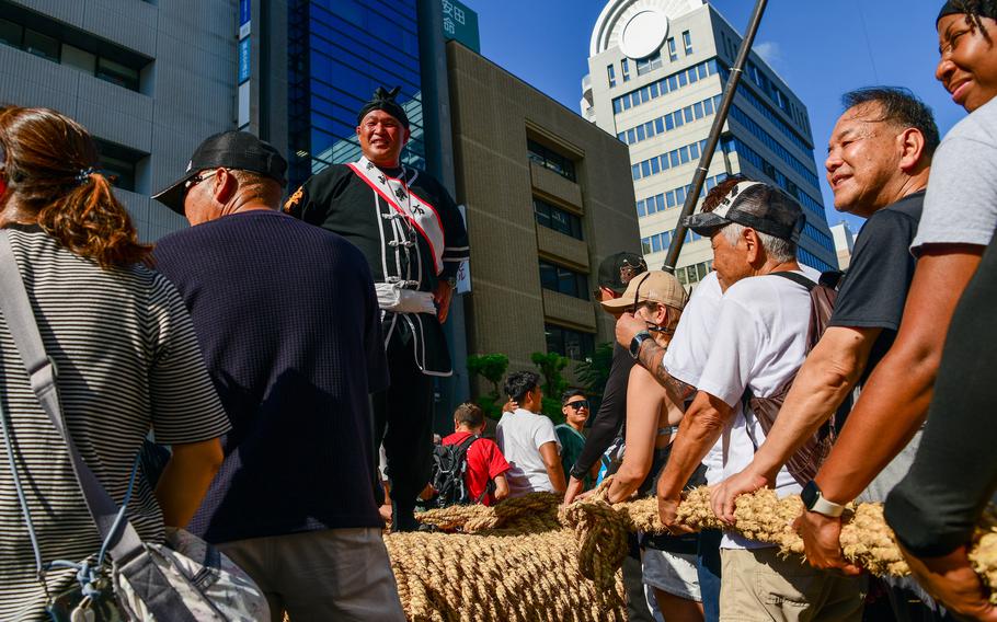 Locals, toursits and U.S. service members wait to witness or participate in the Tug-of-War Festival in Naha, Okinawa, Oct. 12, 2025.