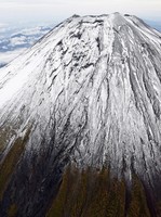 The summit of Mount Fuji with its first snowcap of the season is seen on Oct. 23, 2025, in this photo taken from a Mainichi Shimbun helicopter. (Mainichi)