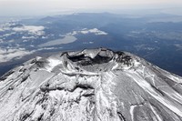The summit of Mount Fuji with its first snowcap of the season is seen on Oct. 23, 2025, in this photo taken from a Mainichi Shimbun helicopter. (Mainichi)