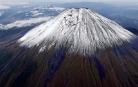 The summit of Mount Fuji with its first snowcap of the season is seen on Oct. 23, 2025, in this photo taken from a Mainichi Shimbun helicopter. (Mainichi)