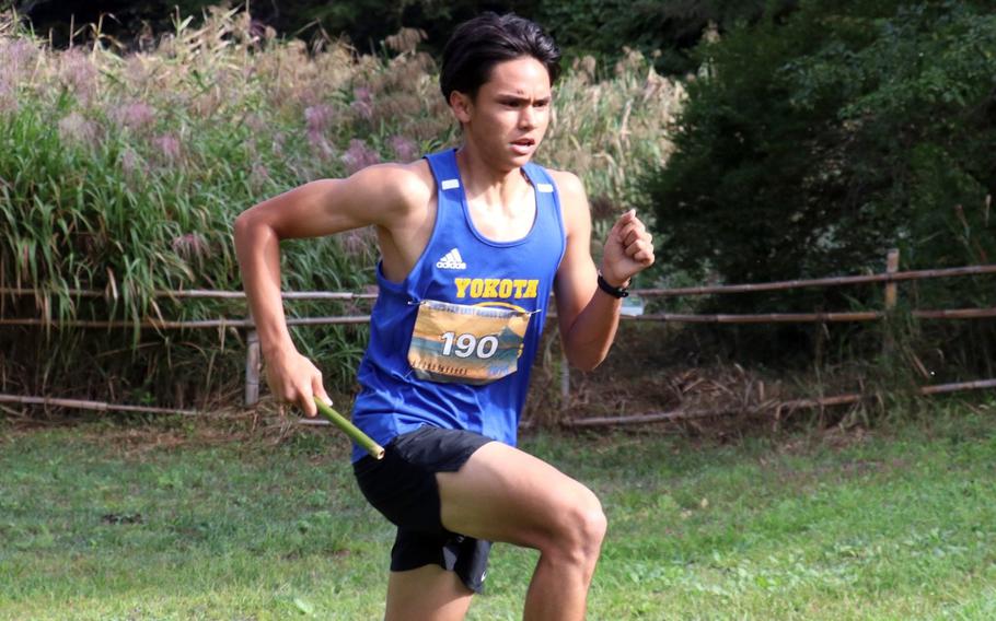 Matthew Rowland runs with a baton.
