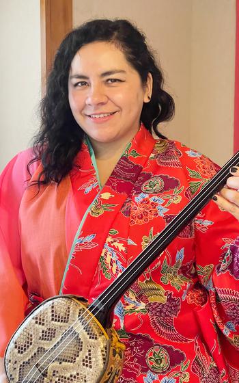 Dennise poses for a photo with sanshin.