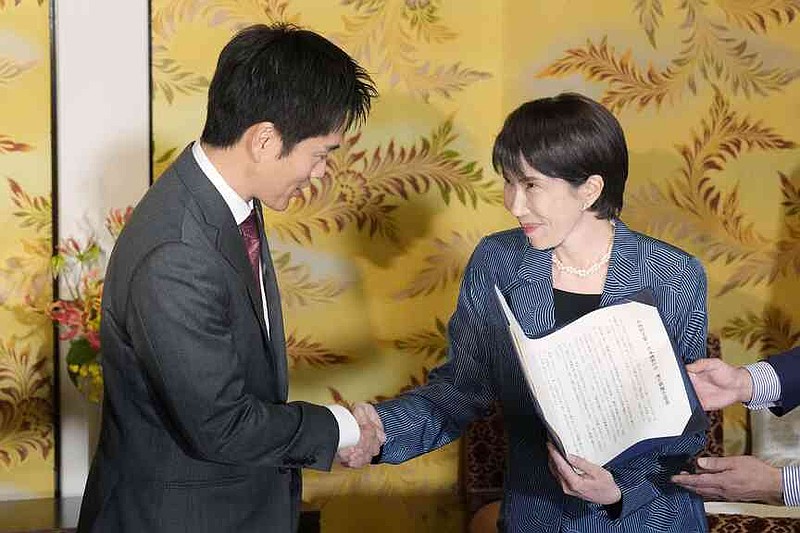Japan's Liberal Democratic Party President Sanae Takaichi, right, and leader of Japan Innovation Party, or Ishin no Kai, Hirofumi Yoshimura shake hands after signing an agreement to form a coalition government in Tokyo, Monday, Oct. 20, 2025. (Kyodo News via AP)