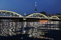The three steel arches of Umaya Bridge are illuminated in this photo taken from the Taito Ward side in Tokyo, June 5, 2023. (Mainichi/Osamu Sukagawa)