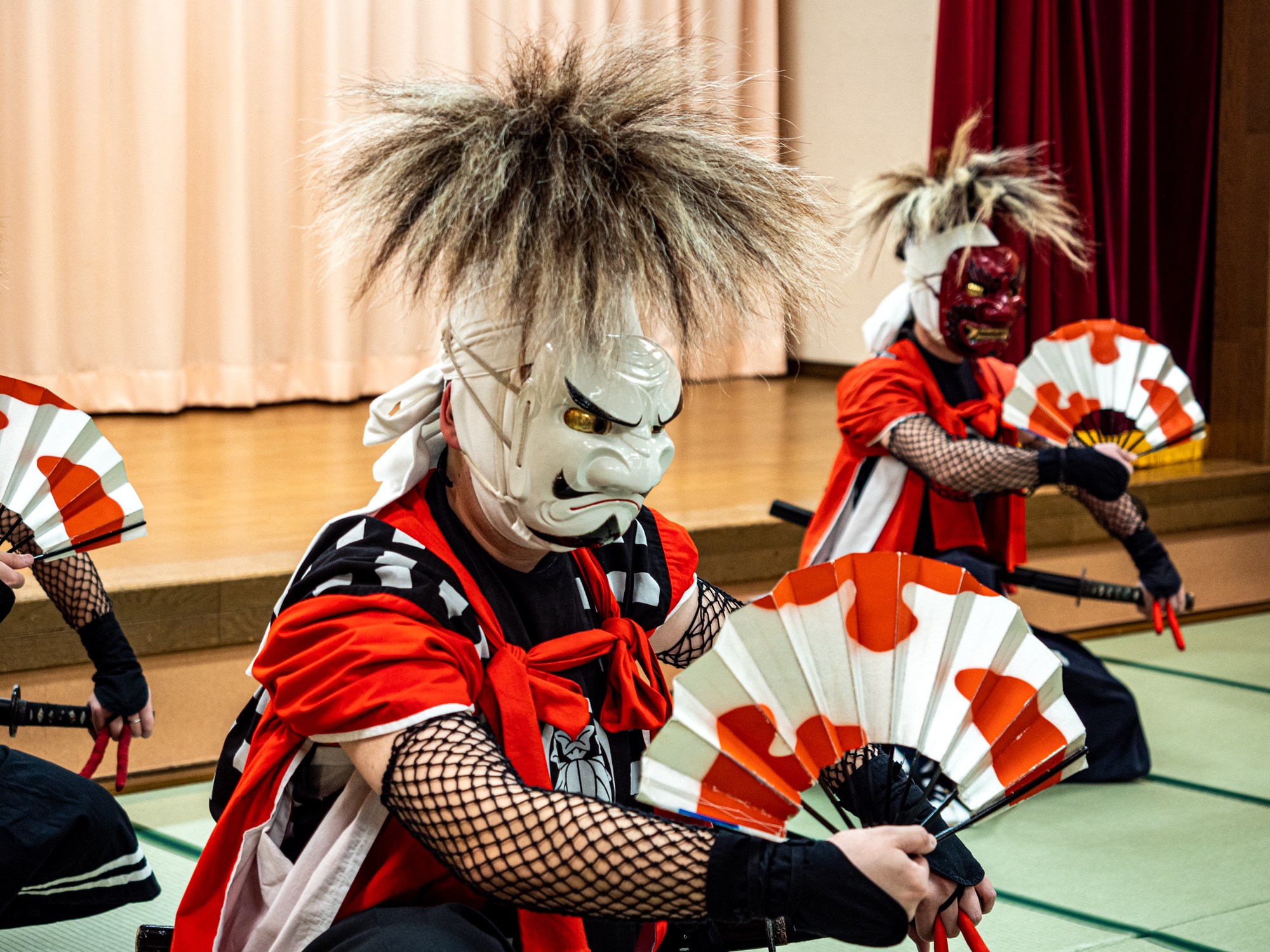 dancers with fans doing the Oni Kenbai
